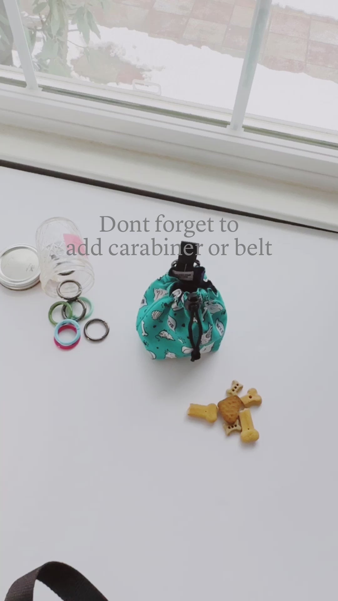 Video shows functional treat bag holder with carabiner or belt as options to add on.